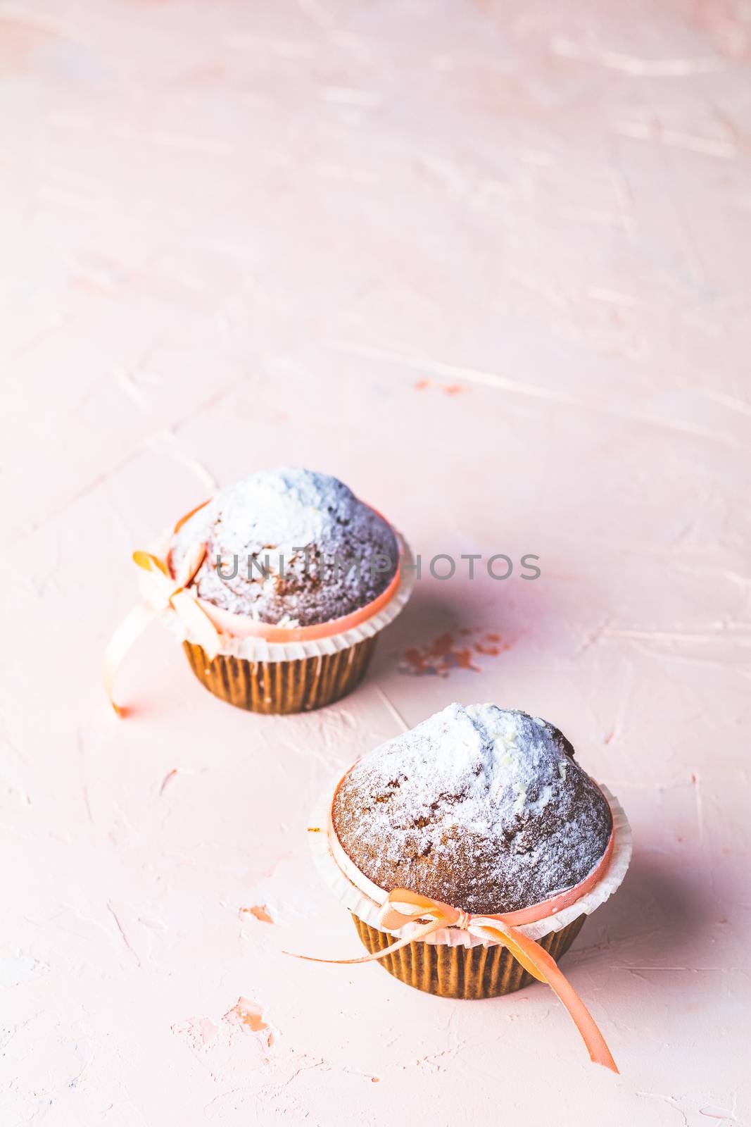 Homemade muffin on light pink living coral stone concrete surfac by ArtSvitlyna