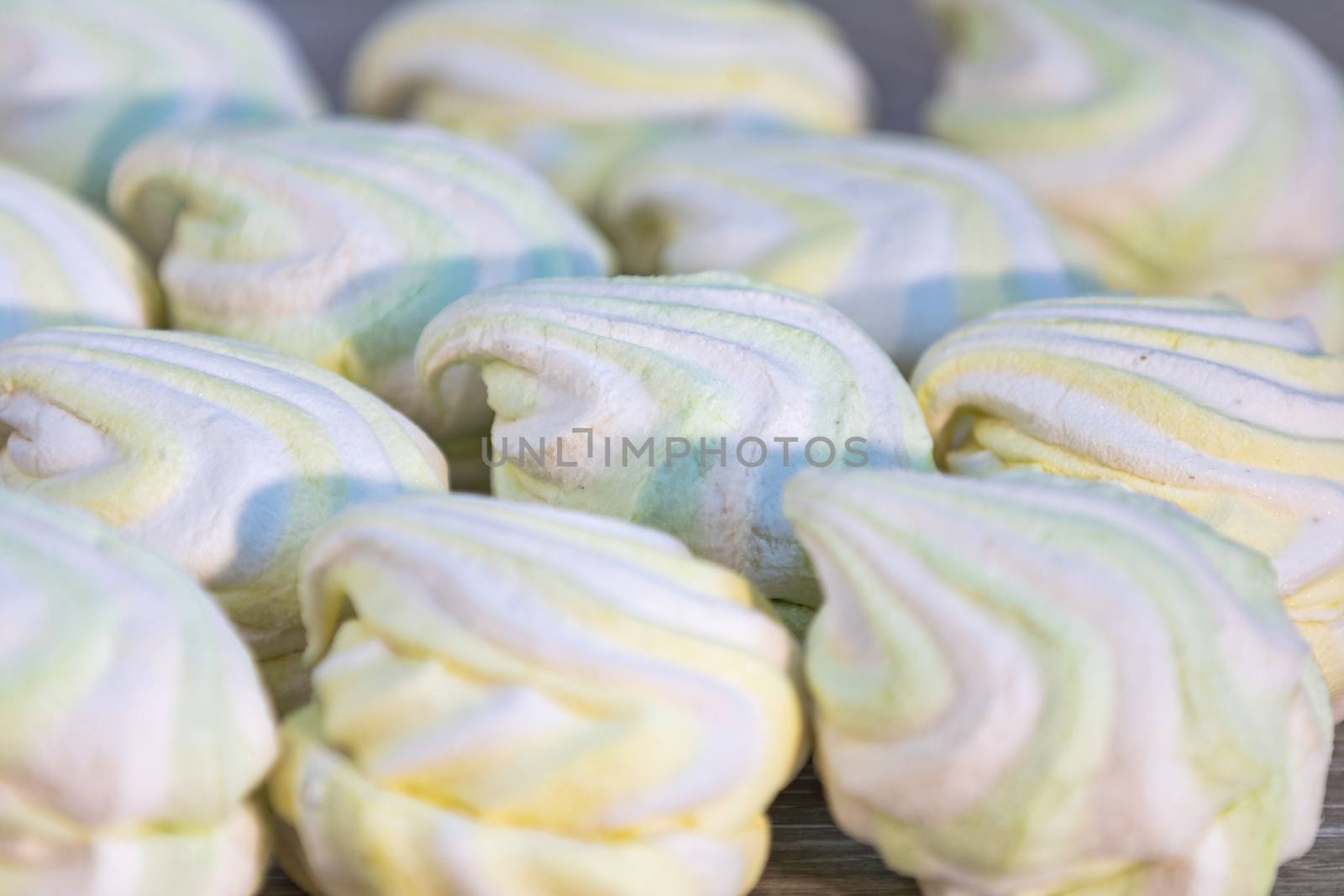 Background or texture of colorful marshmallows on light table background. Shallow depth of the field.