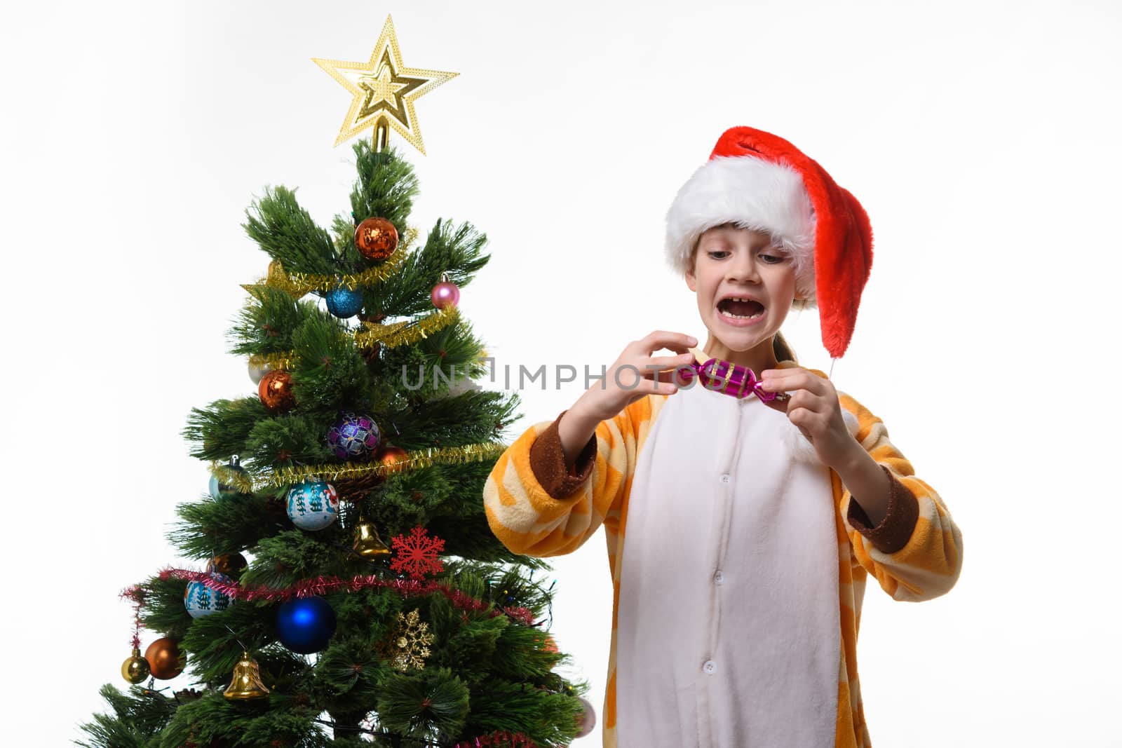 Girl has fun holding a candy-shaped Christmas toy