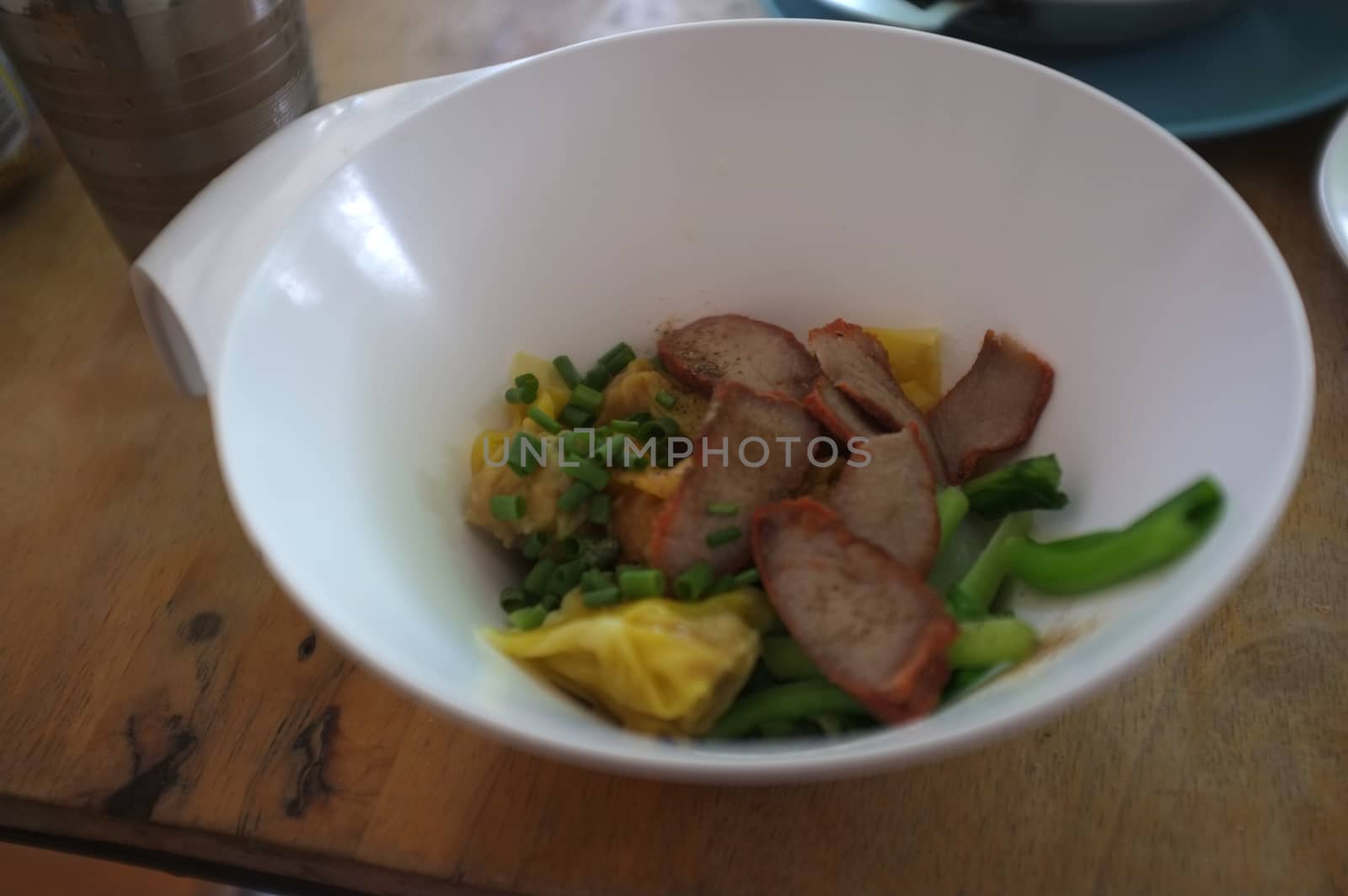 Wantan egg noodles and sliced roasted red pork . Asian street food by Hepjam