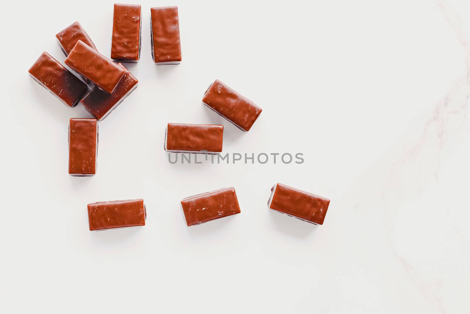 Milk chocolate candies isolated on white background, sweet food and dessert by Anneleven