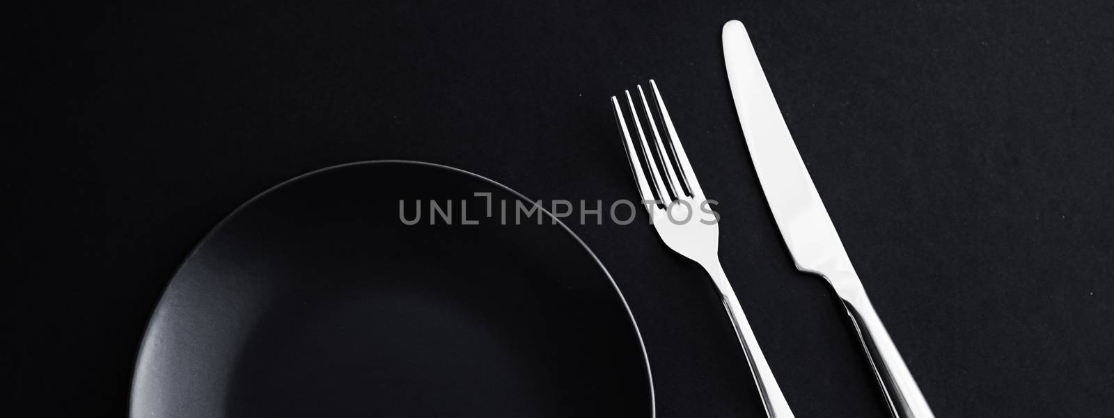 Empty plates and silverware on black background, premium tableware for holiday dinner, minimalistic design and diet by Anneleven