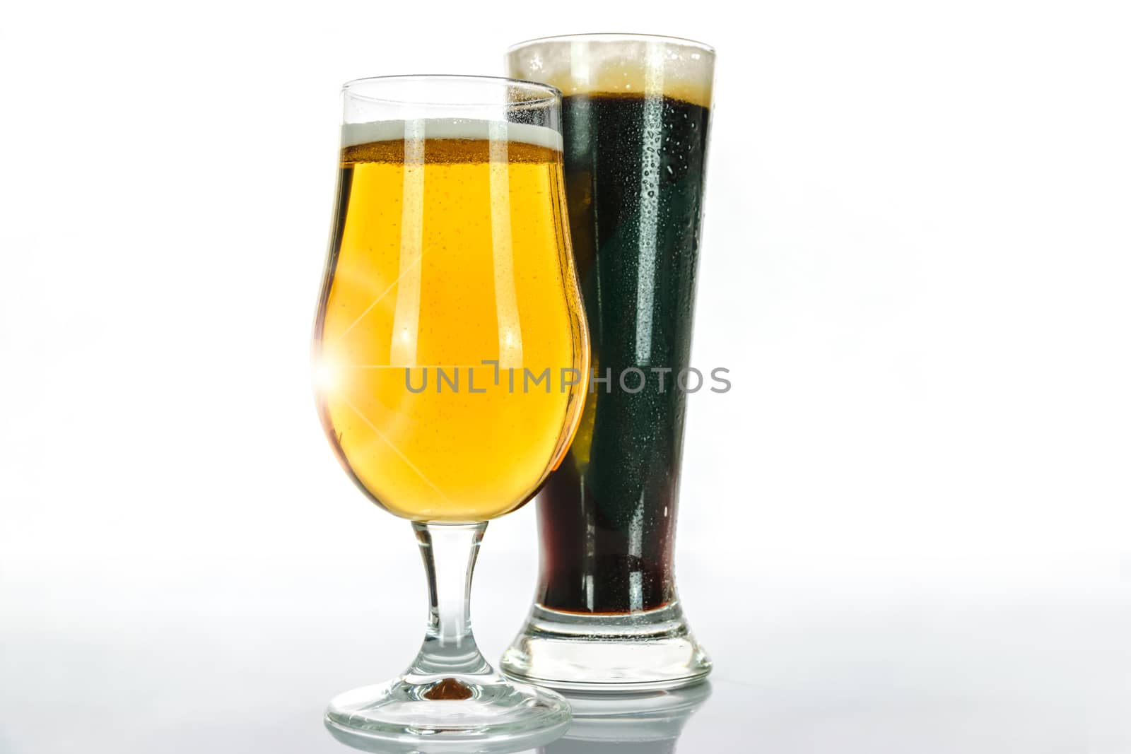 Light beer and dark beer in two glasses on a white background