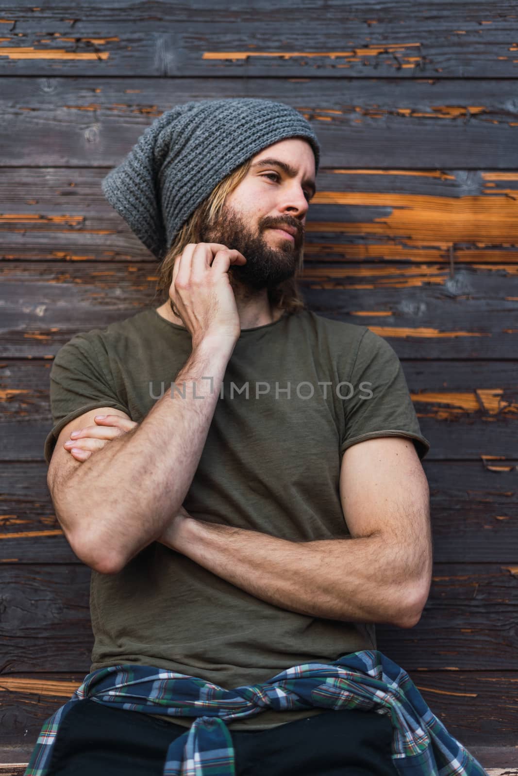 Portrait of young bearded man while he is looking the other side