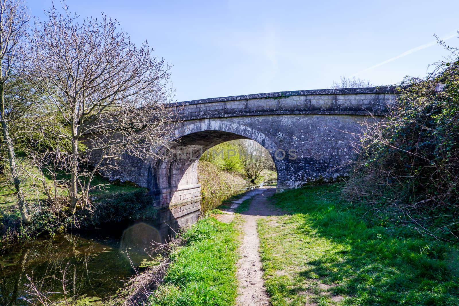 Scenic View of on the Lancster Canal Bathed in Warm Morning Sunlight Running through Cumbria England by paddythegolfer