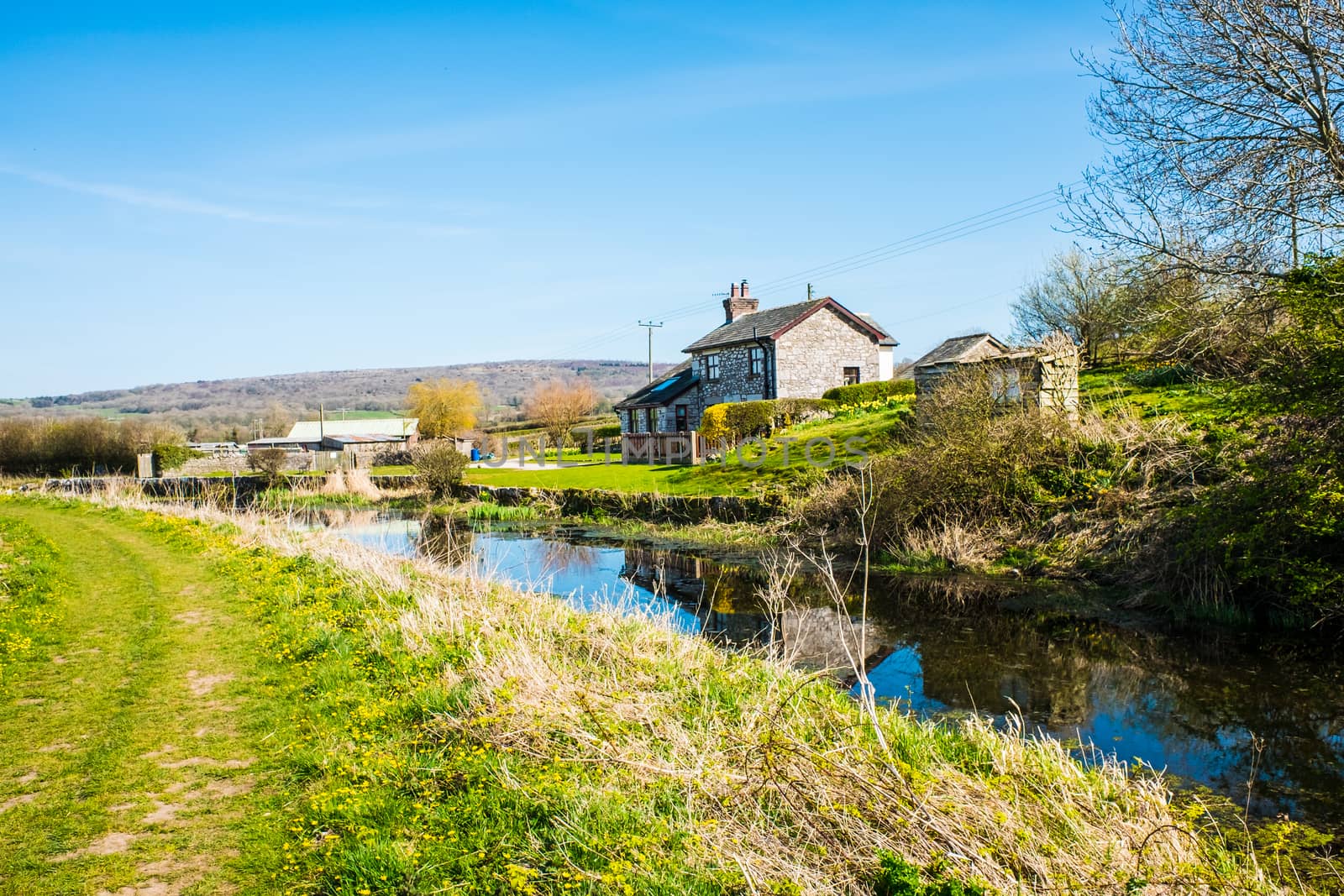 Scenic View of Cottage Bathed in Warm Morning Sunlight on the Lancster Canal Running throughCumbria