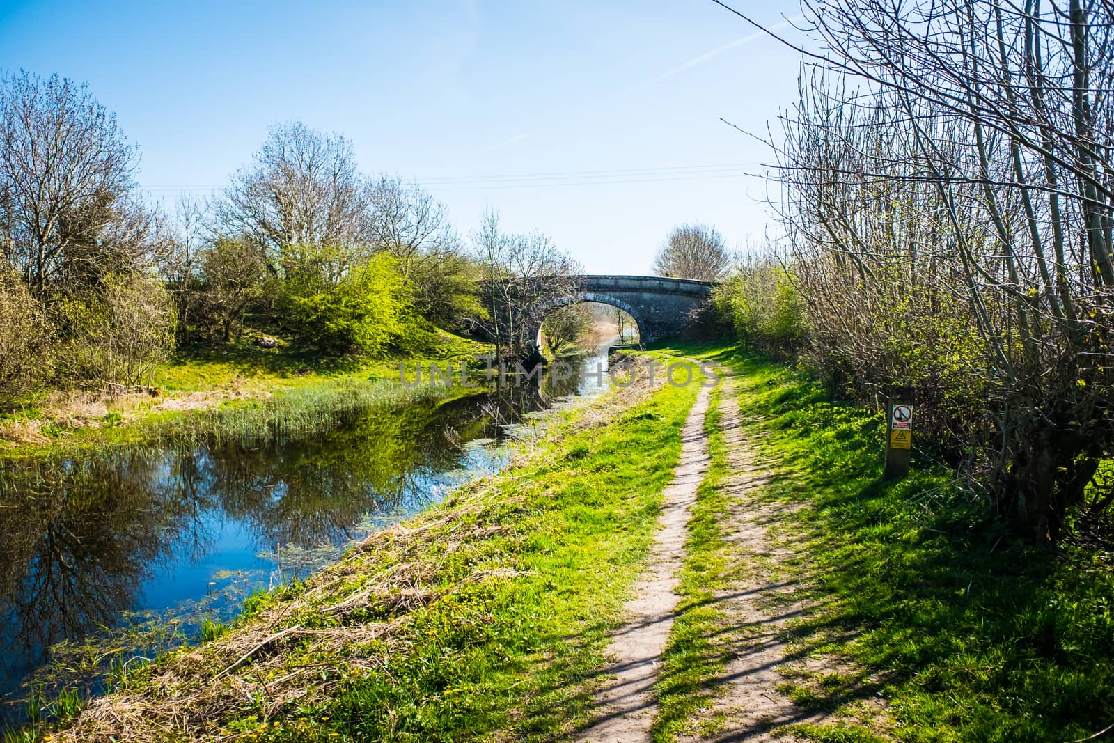 Scenic View of on the Lancster Canal Bathed in Warm Morning Sunlight Running through Cumbria England by paddythegolfer