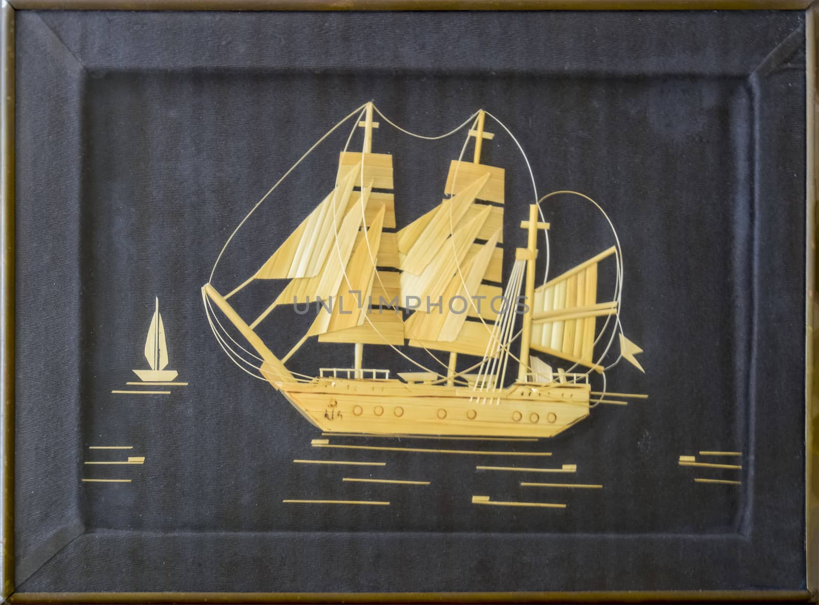 A pattern of wood chips. Sailing ship at sea. Black background. Craft ship sailing from wood chips.