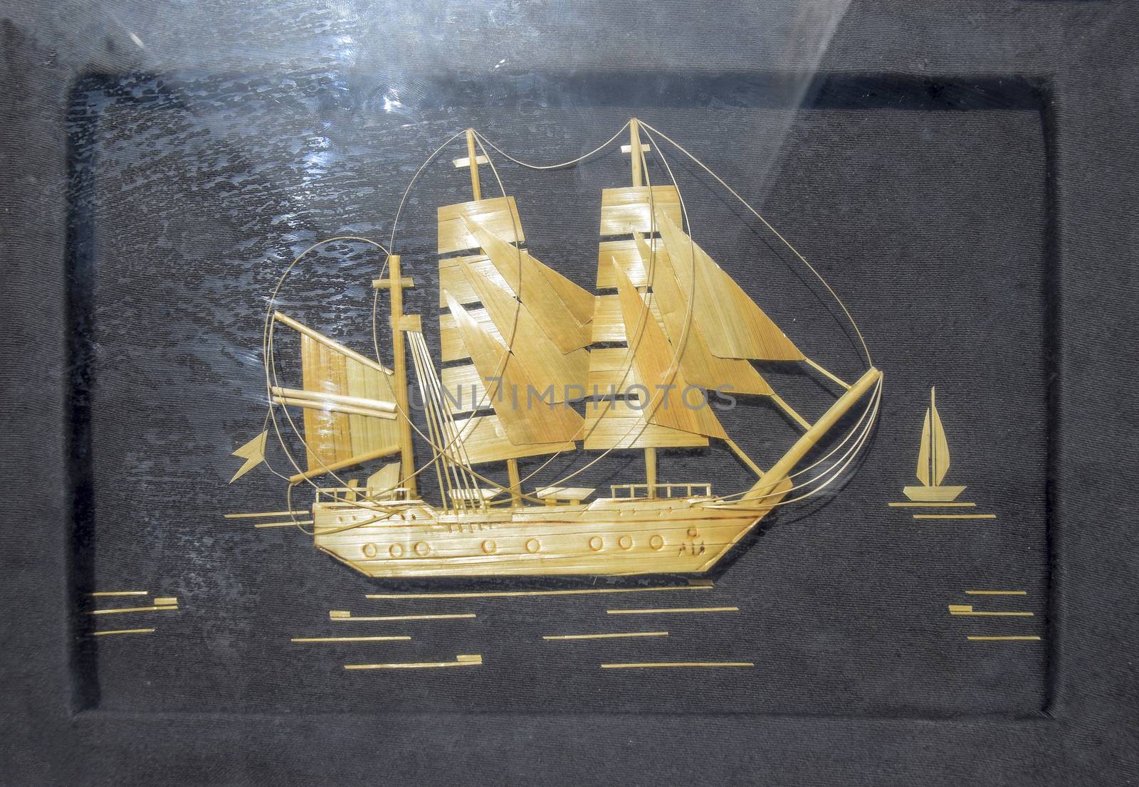 A pattern of wood chips. Sailing ship at sea. Black background. Craft ship sailing from wood chips.