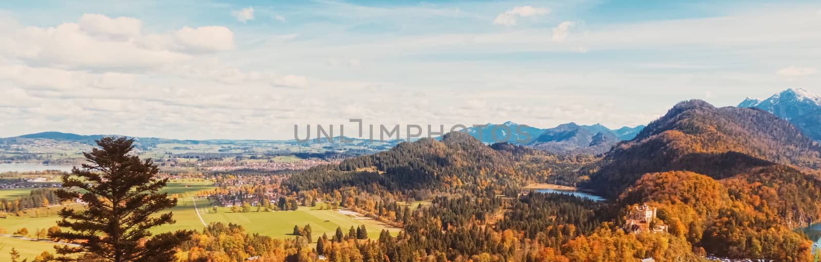 Beautiful nature of European Alps, landscape view of alpine mountains, lake and village in autumn season, travel and destination scenery