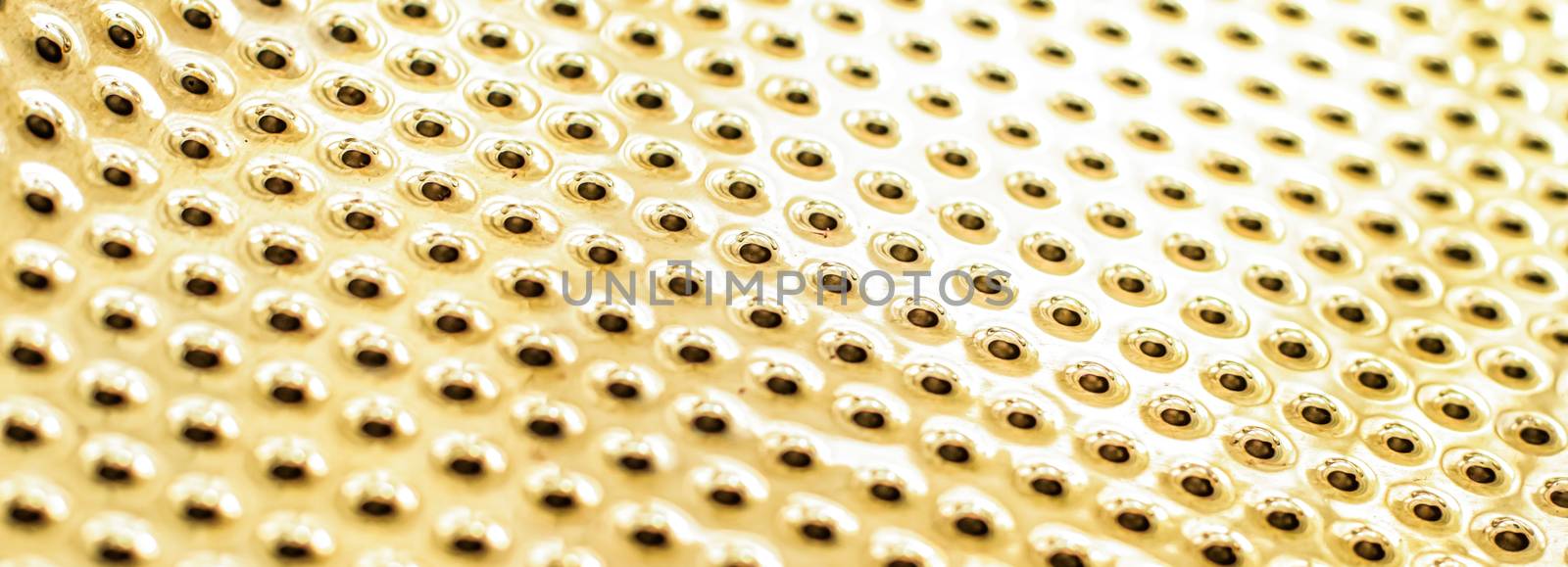 Texture of golden metallic surface as background, materials and interior design concept