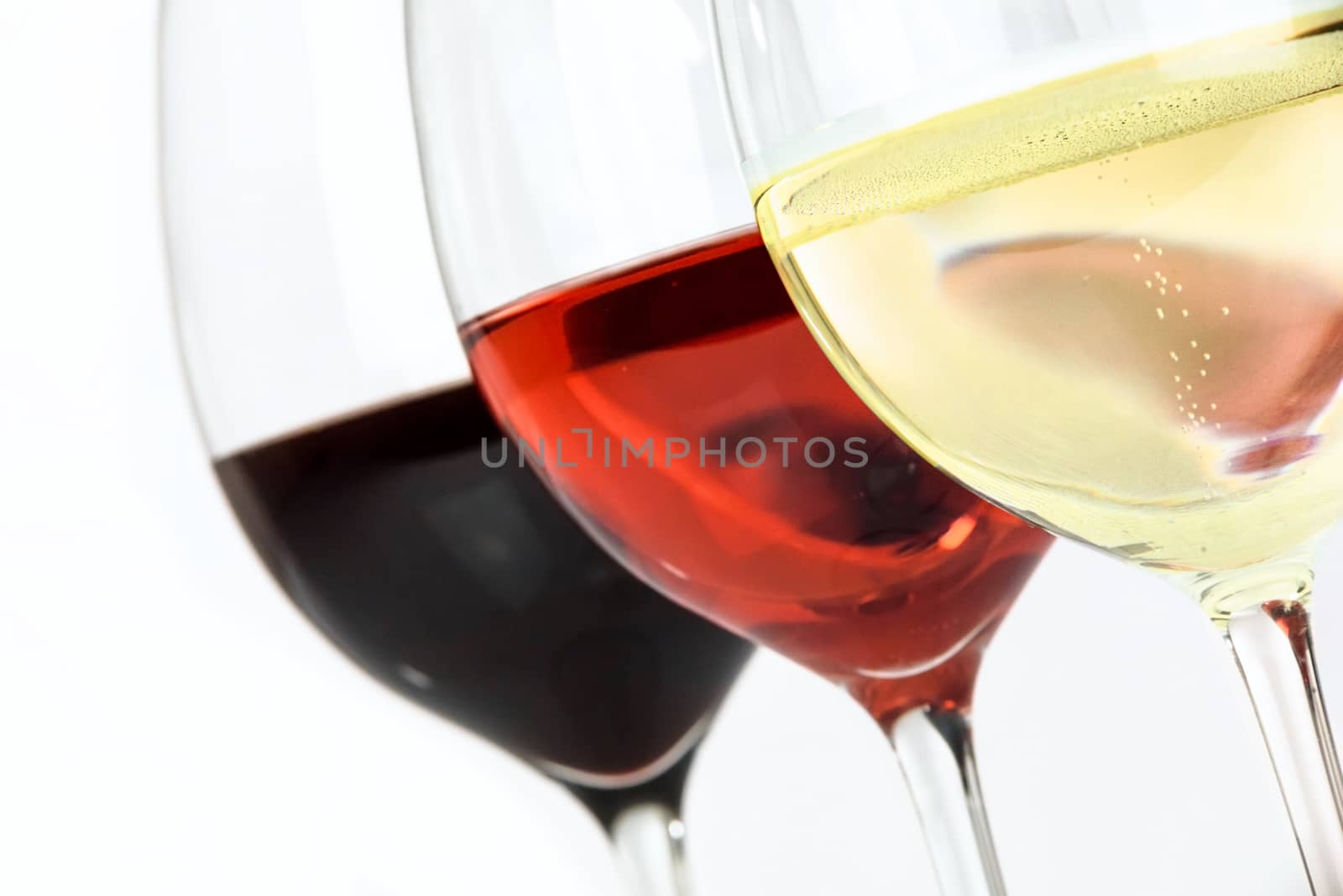 Three glasses of wine with white wine, rose and red on a white background