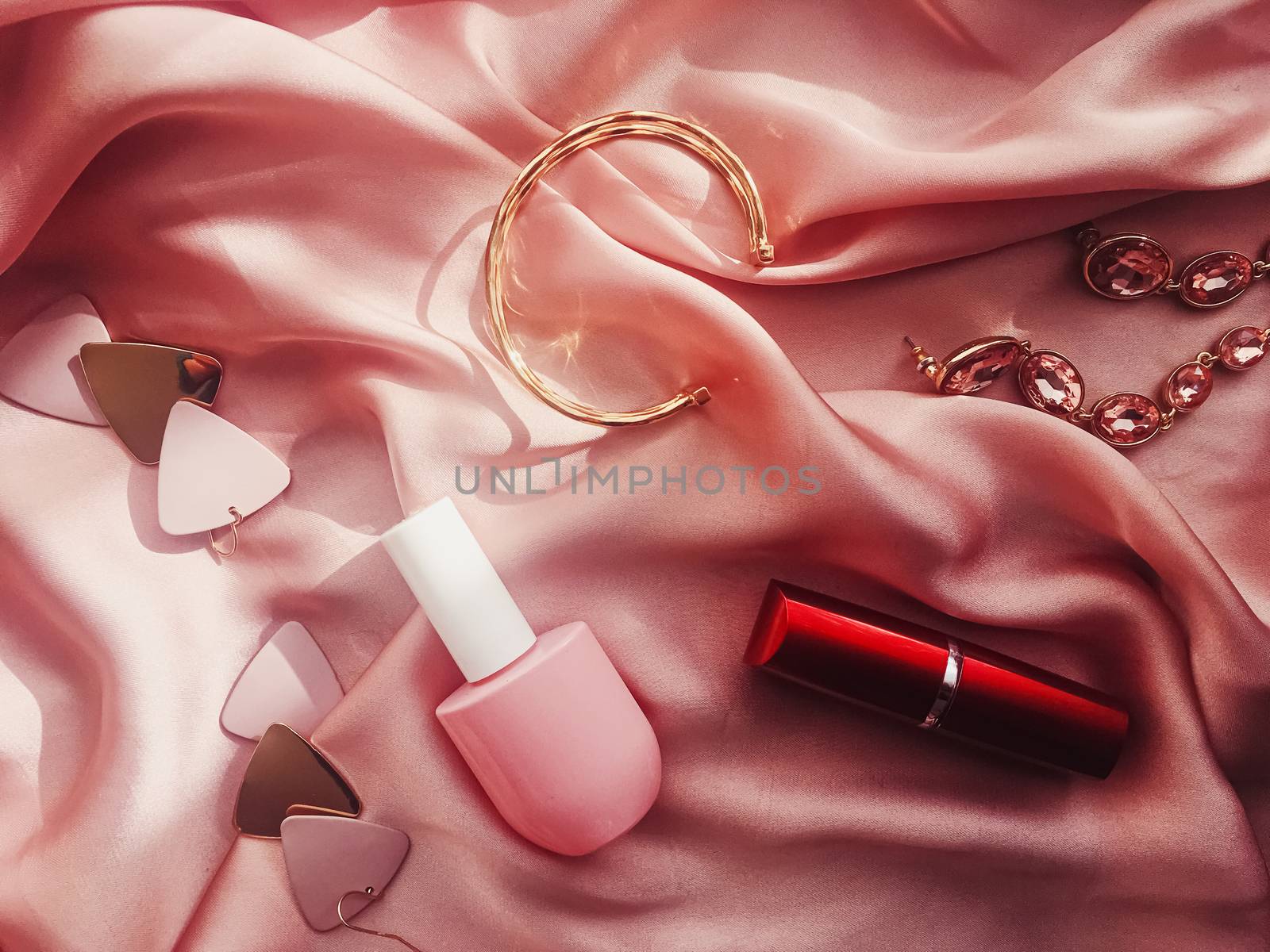 Fashionable and stylish accessories, jewelry and make-up products on pink silk background, beauty and fashion by Anneleven