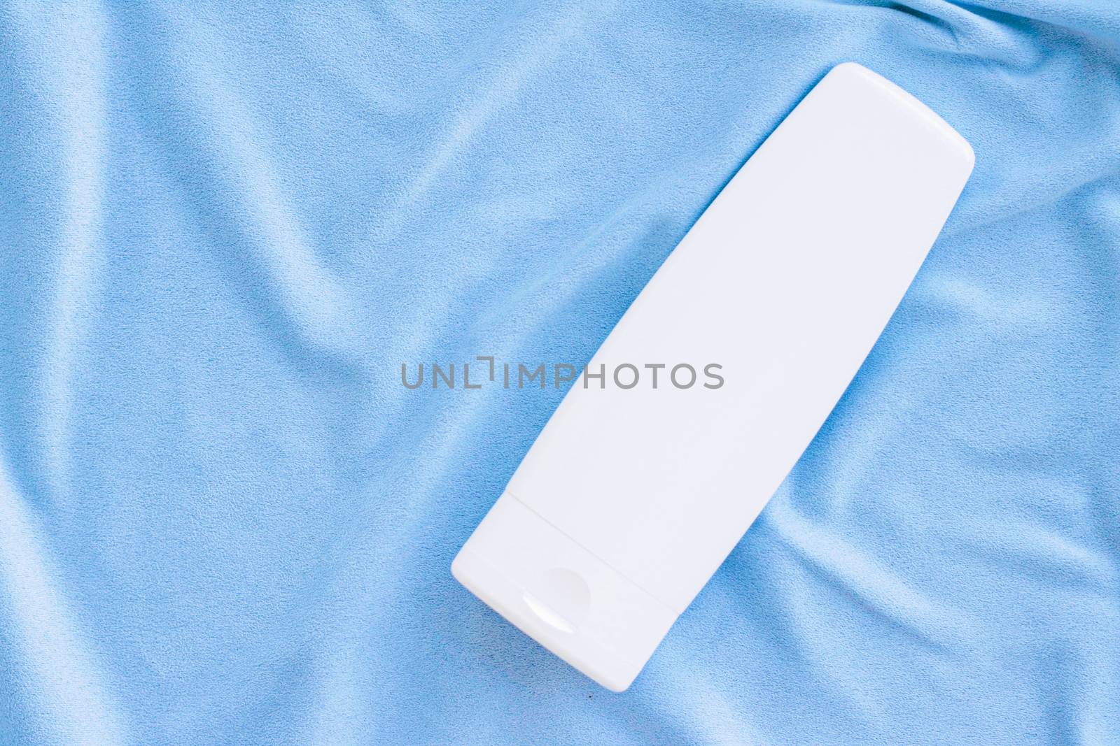 Blank label tube of hand cream or body lotion mockup on silk fabric, beauty product and skin care cosmetics, flatlay