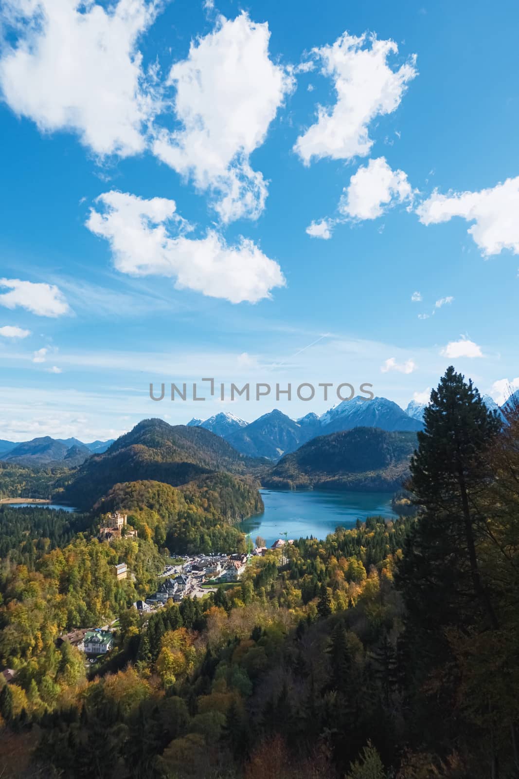 Beautiful nature of European Alps, landscape view of alpine mountains, lake and village on a sunny day, travel and destination by Anneleven
