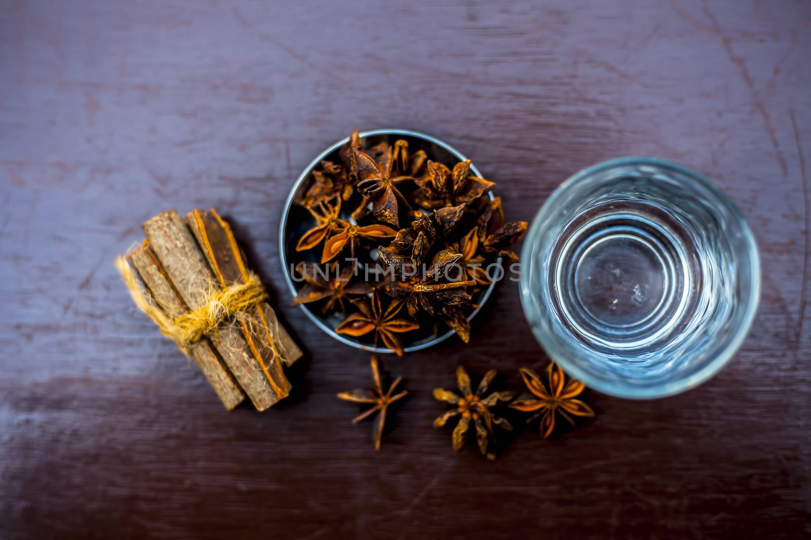 Face mask for wrinkles on the wooden surface consisting of some cinnamon sticks, water, and star anise seed powder. by mirzamlk