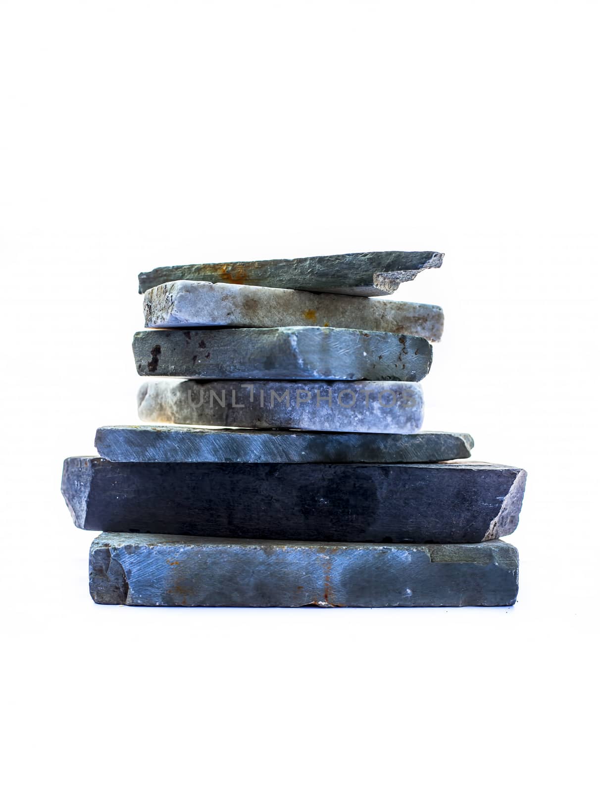 Vertical shot of a bunch of rocks stacked on each other. Isolated on a white background. by mirzamlk