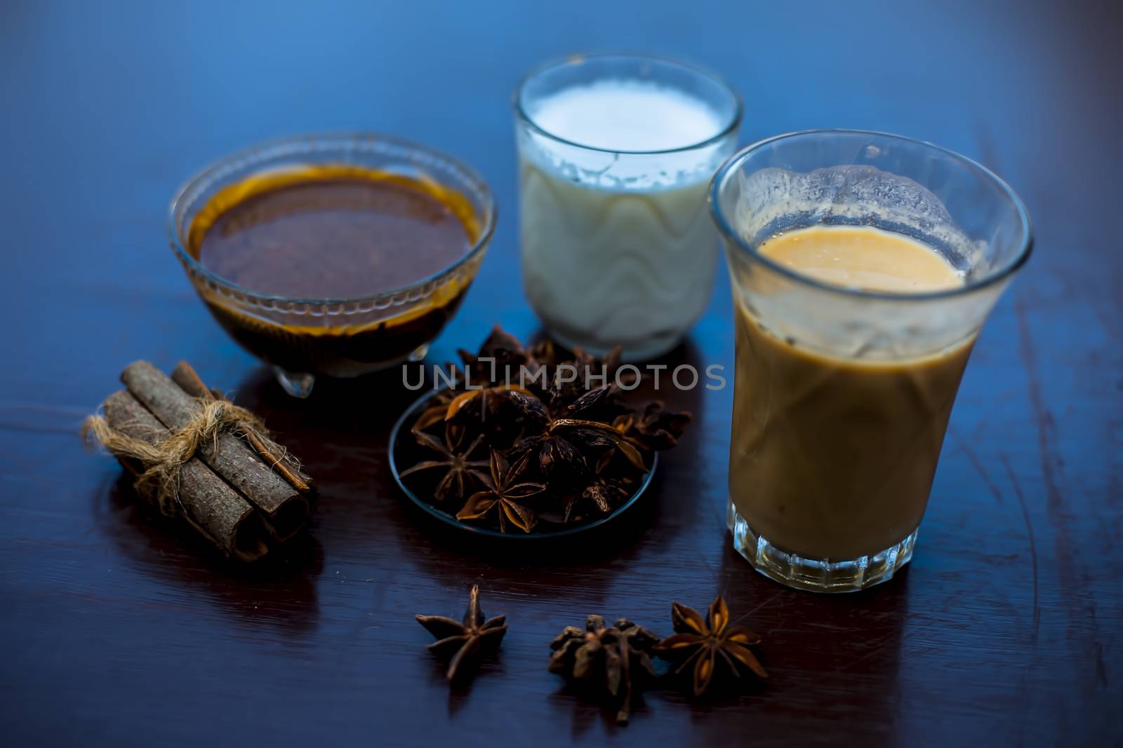 Close up shot of a glass of Star Anise Milk consisting of some star anise powder, milk, and licorice powder. Horizontal shot. by mirzamlk