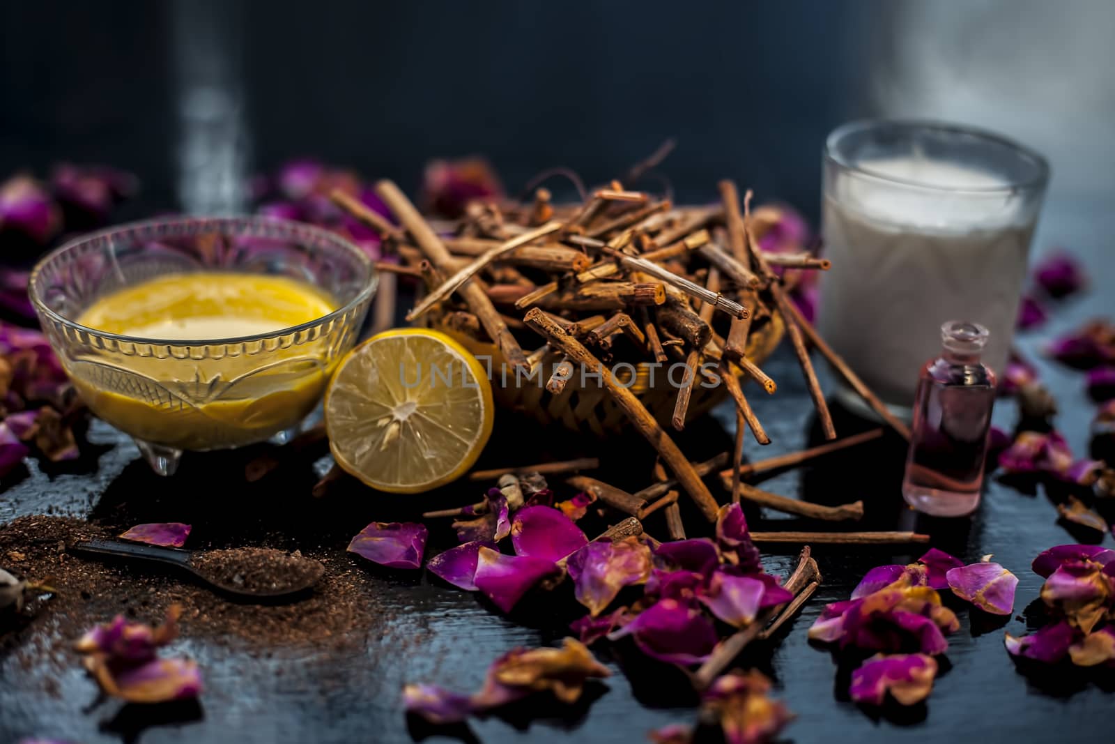 Face mask of manjistha or Indian madder root on a black wooden surface consisting of manjistha roots powder, lemon, milk and some essential rose oil. Face mask used for minor skin infections and acne. by mirzamlk