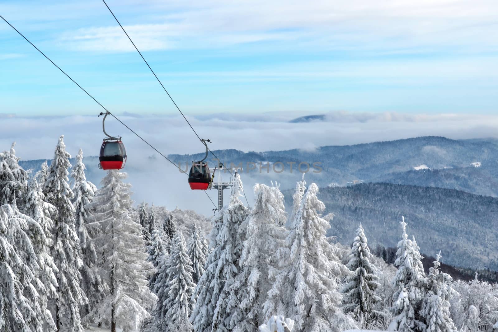 Gondola ski lift on a background of a picturesque winter mountain