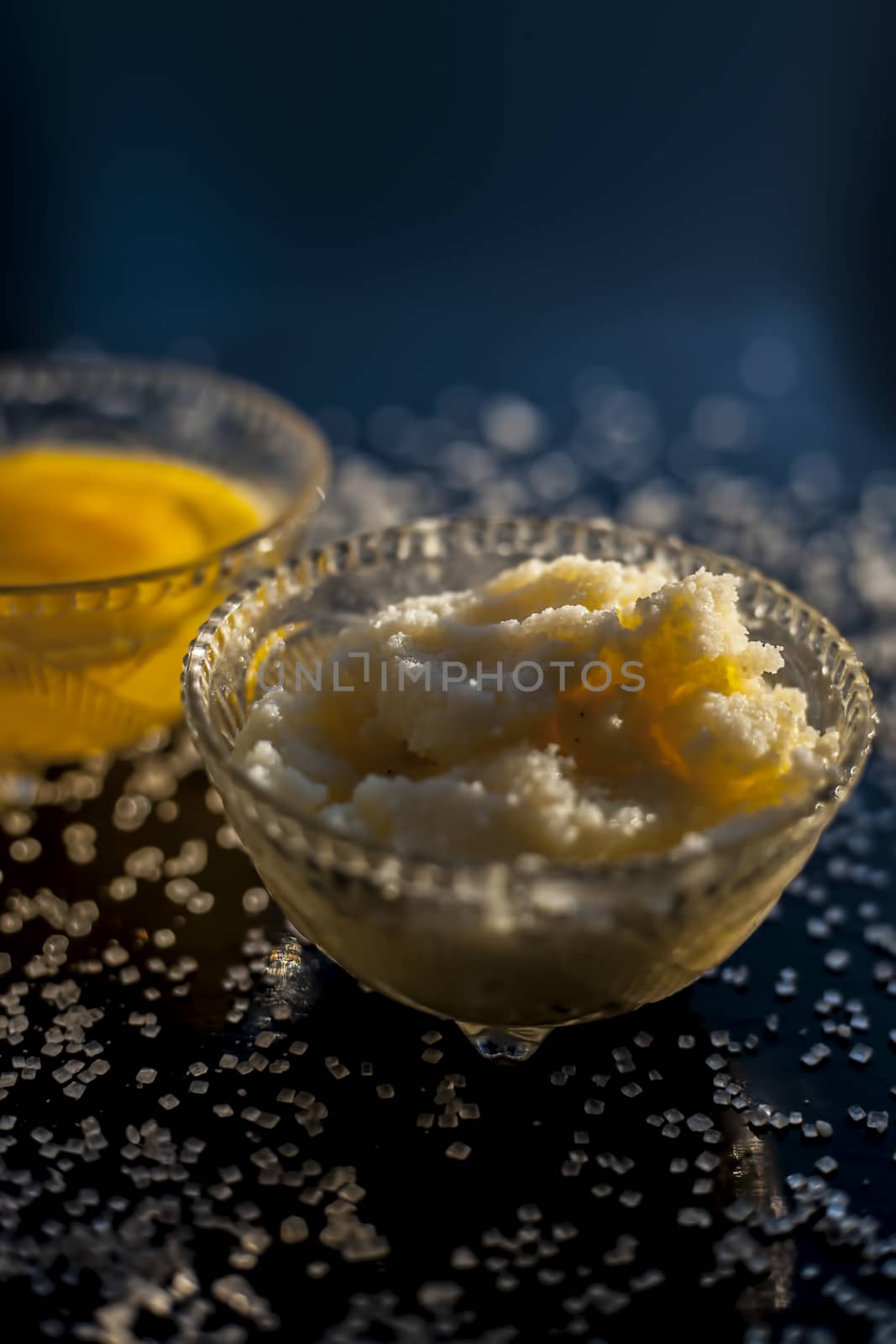 Close up shot of ayurvedic method or calcium supplement on the black surface consisting of raw eggs, milk, and ghee or clarified butter along with some sugar as a sweetener. by mirzamlk