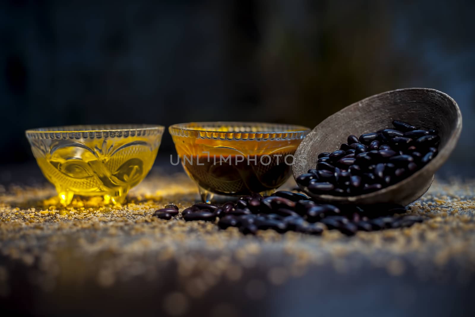 Home pore remedy on the black glossy surface consisting of some red beans or kidney beans mung beans and some green tea. Well mixed together in a bowl. Face mask for pore prevention.Horizontal shot. by mirzamlk