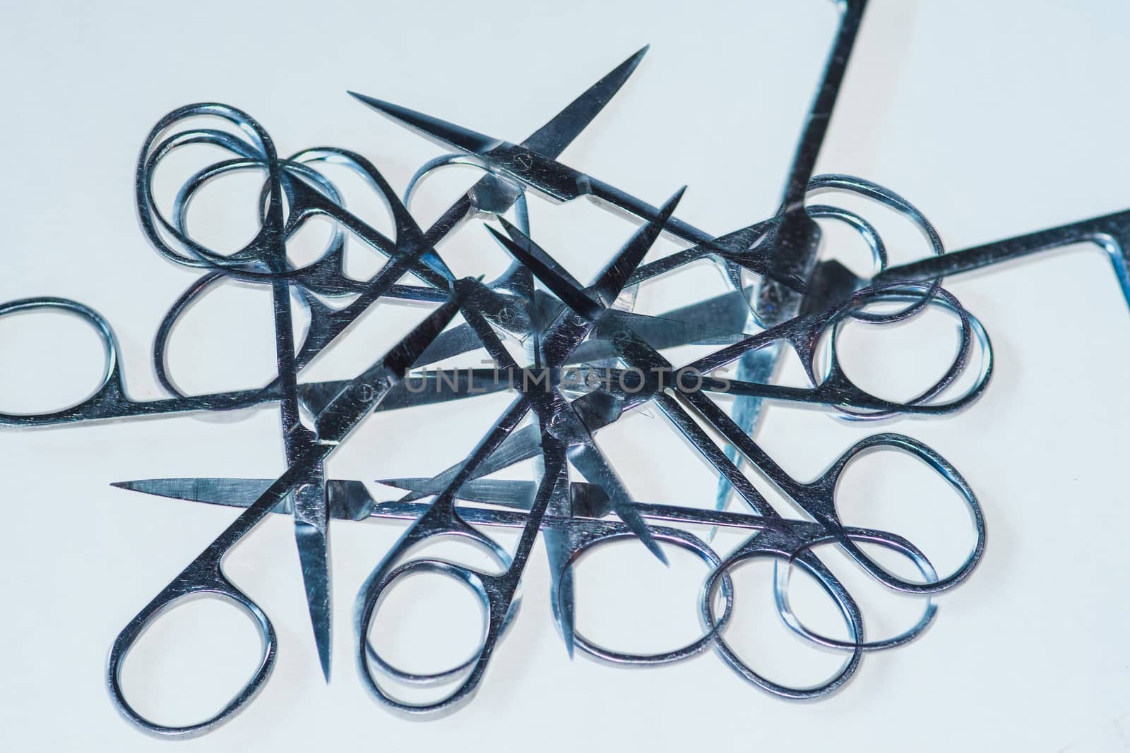 double exposure of small scissors on a plain white background UK