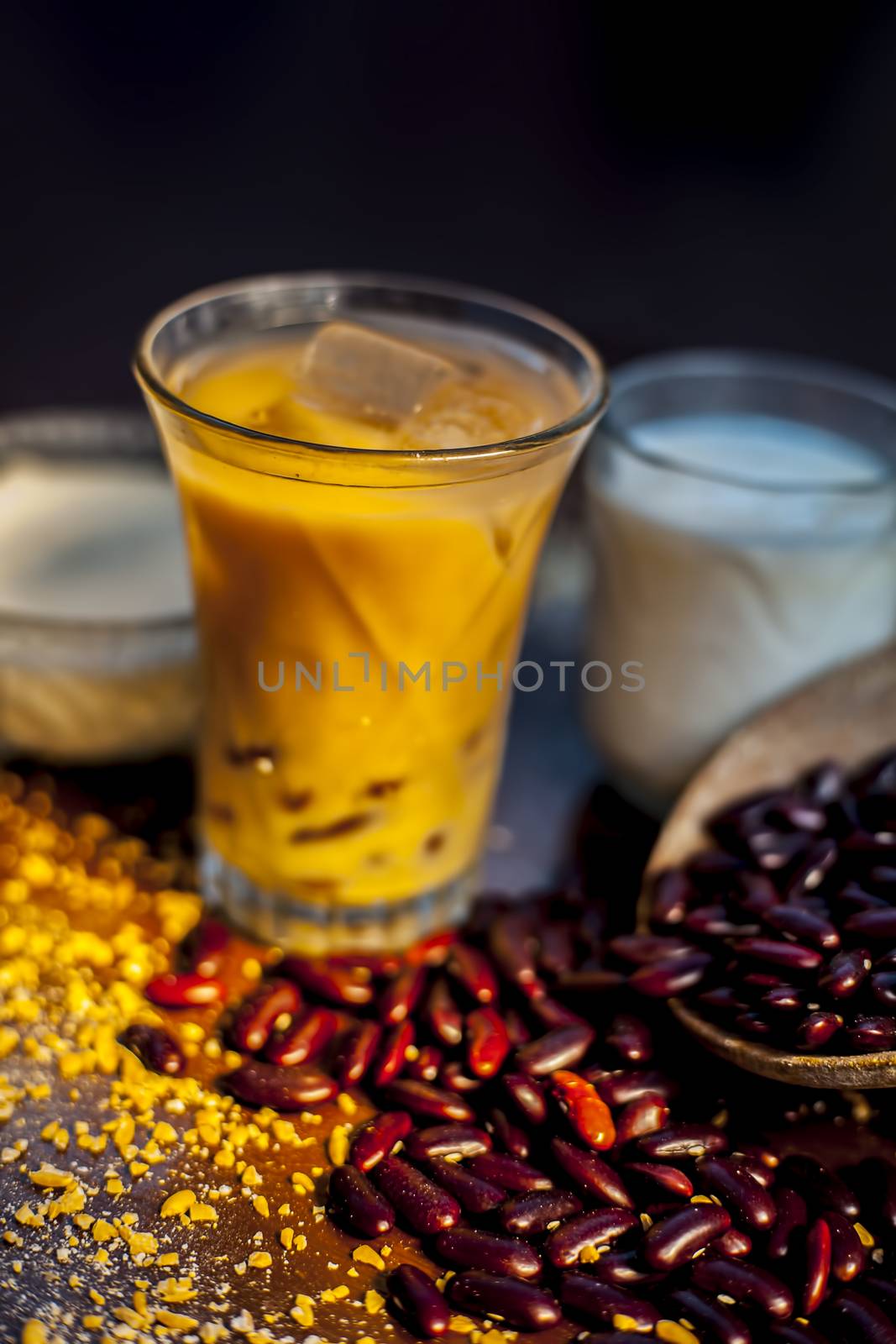 Red bean or kidney bean smoothie in a glass along with some red bean paste, banana, yogurt, milk, and oatmeal. Vertical shot. by mirzamlk