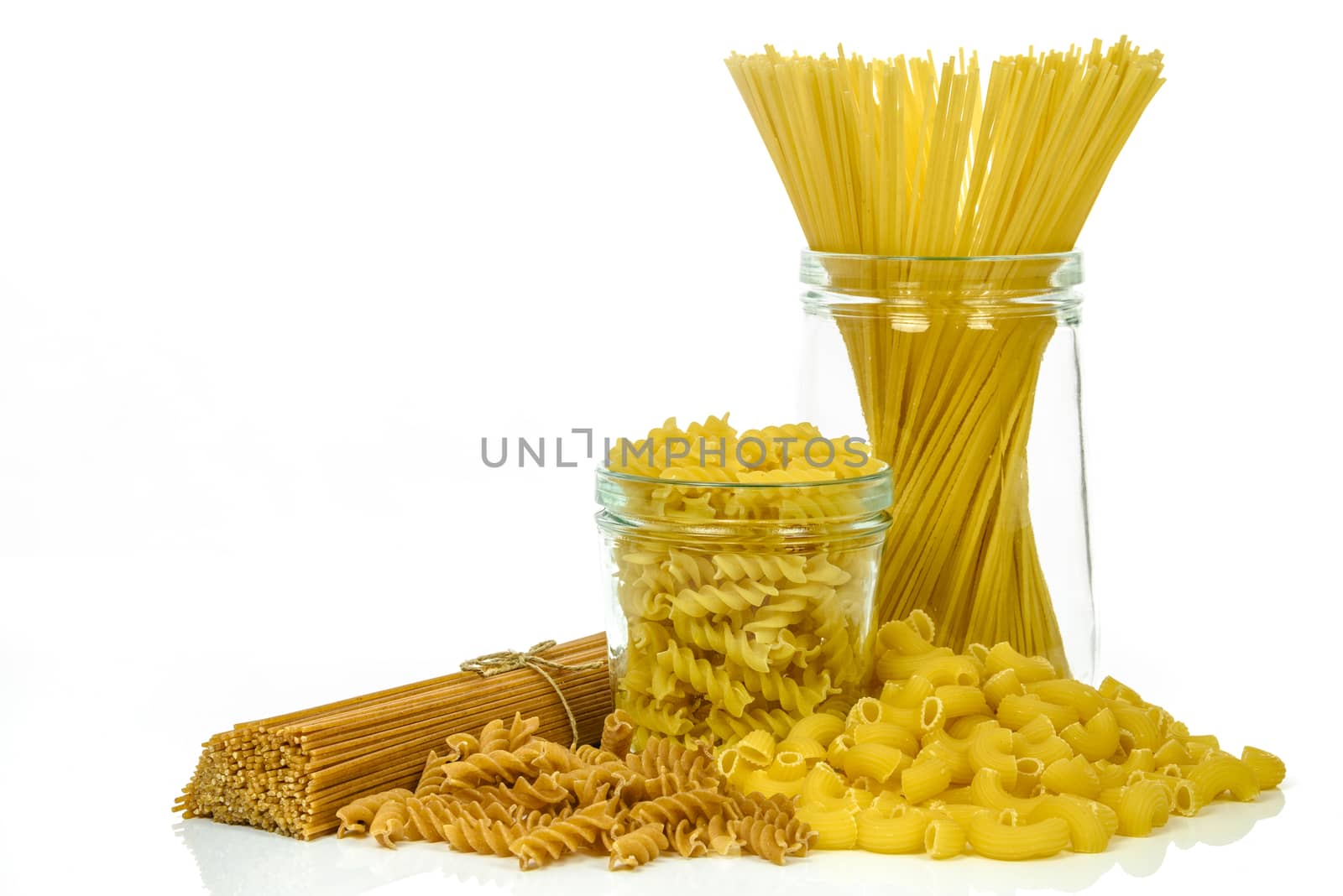 Mixed uncooked raw italian pasta isolated on white background