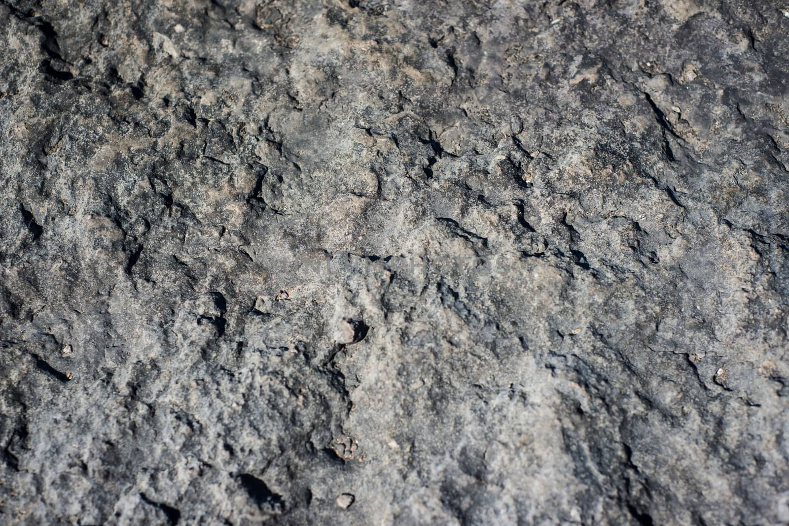 Grey textured stone background in breakwater at Morecambe by paddythegolfer