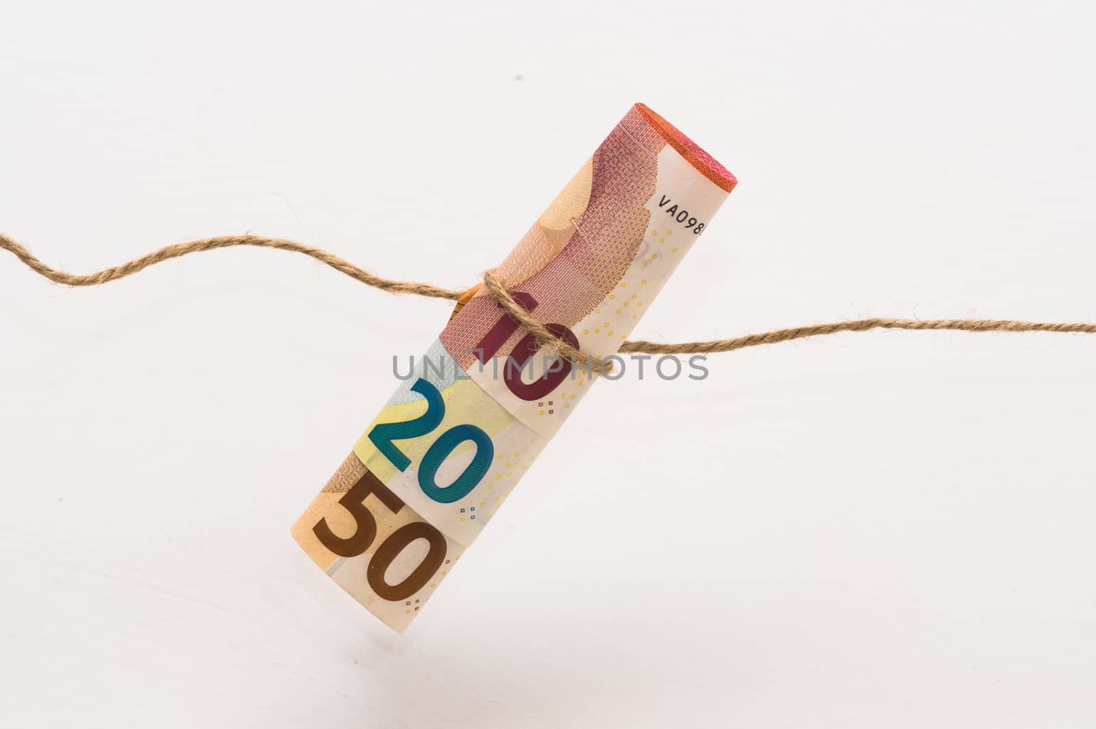 roll of euro money banknotes tied with string by paddythegolfer