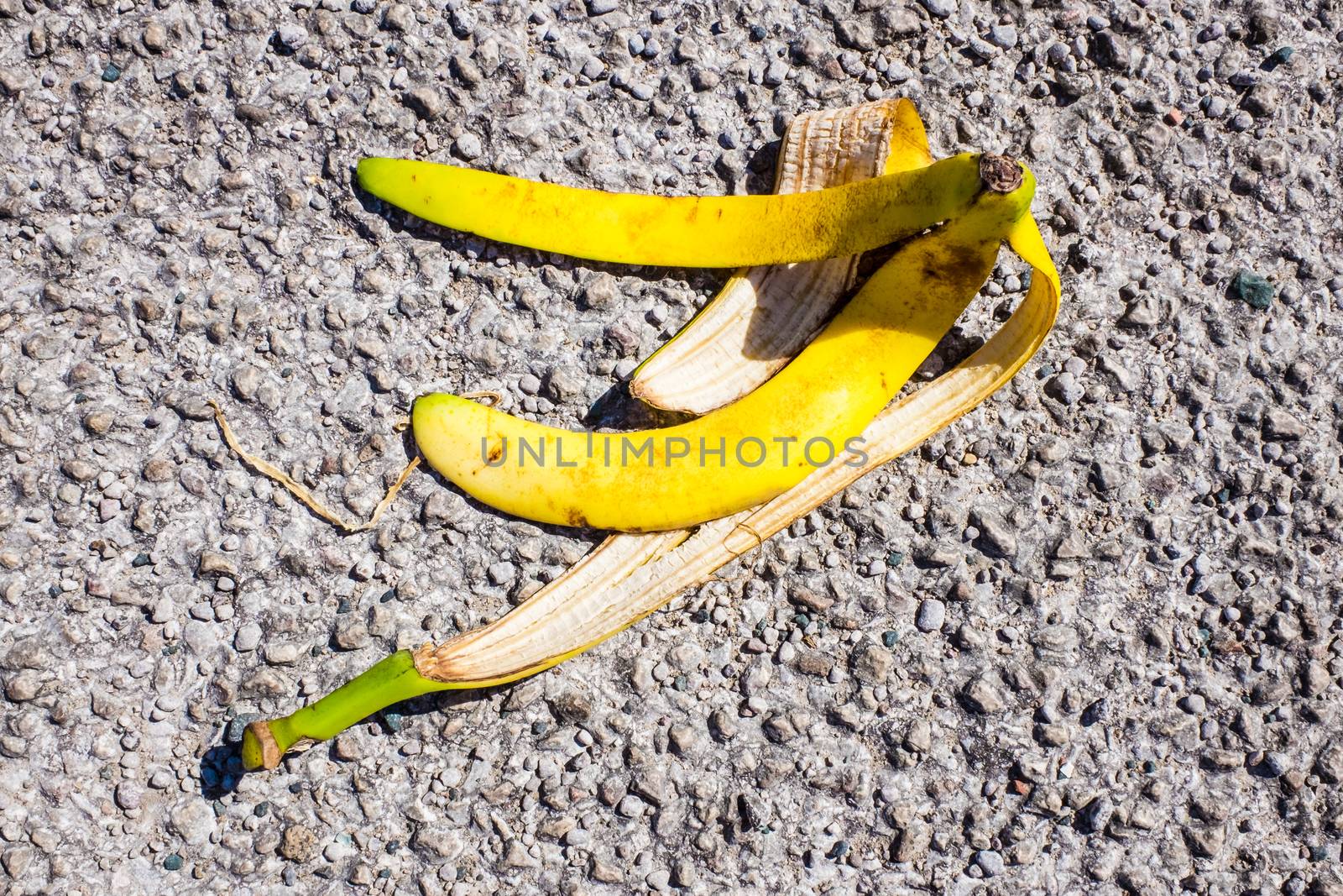 slippery banana peel laying on ground ready to make someone slip and fall by paddythegolfer