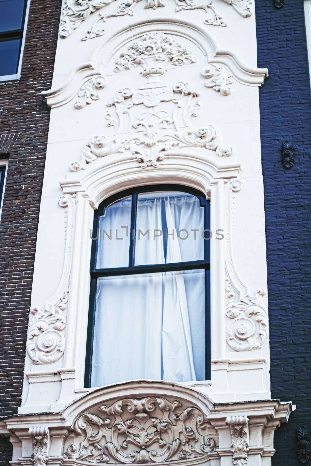 Architectural detail of a building on the main city center street of Amsterdam in Netherlands, european architecture