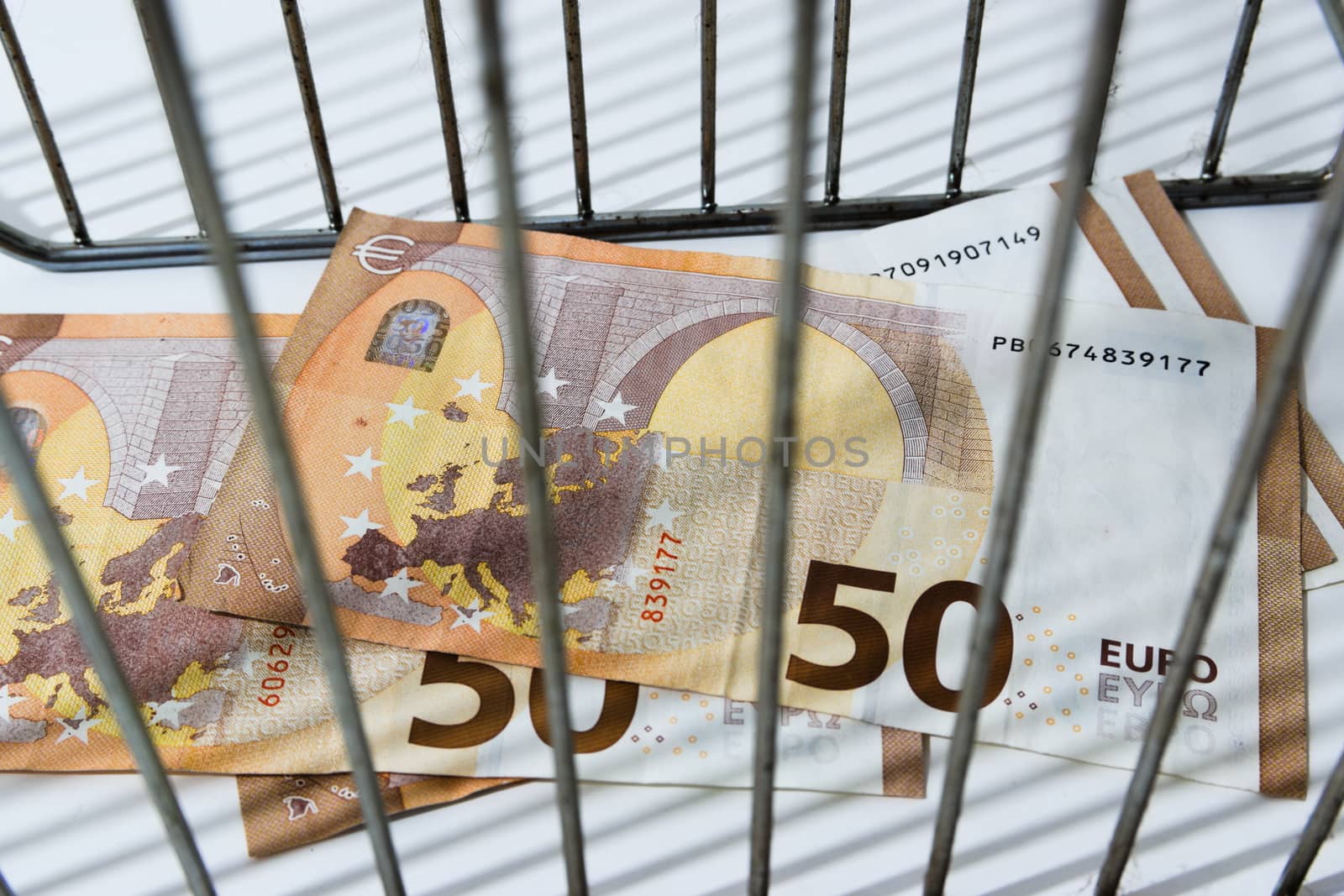 close up of fifty euro money banknote behind bars by paddythegolfer