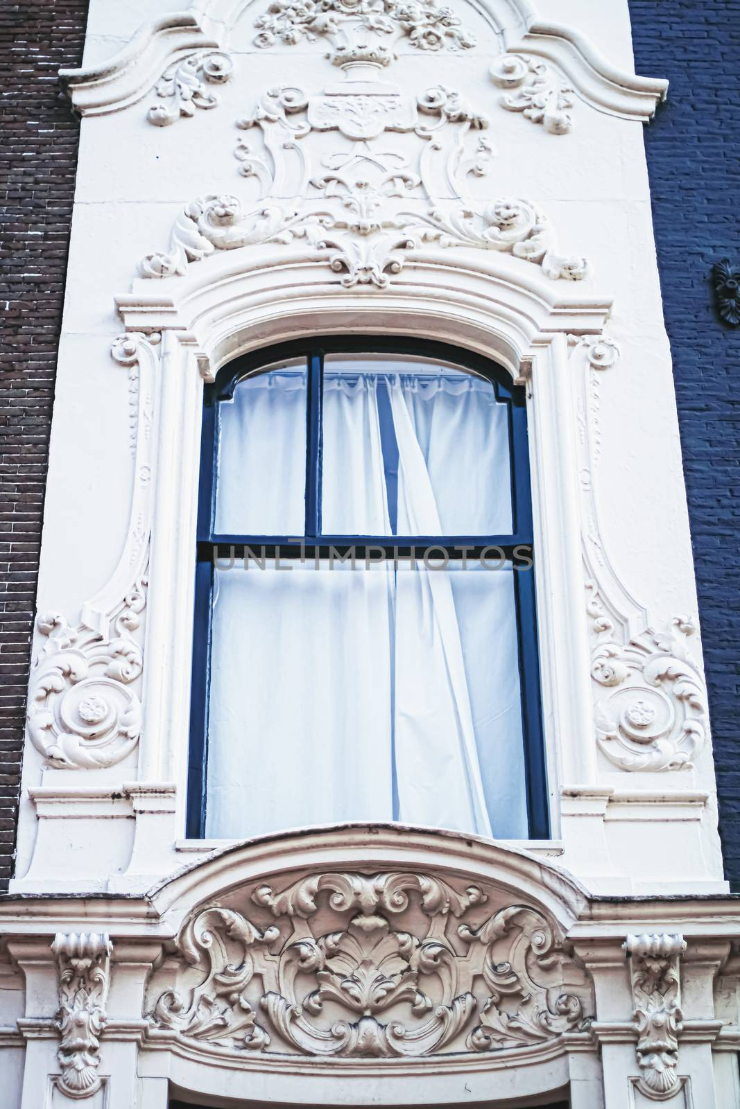 Architectural detail of a building on the main city center street of Amsterdam in Netherlands, european architecture