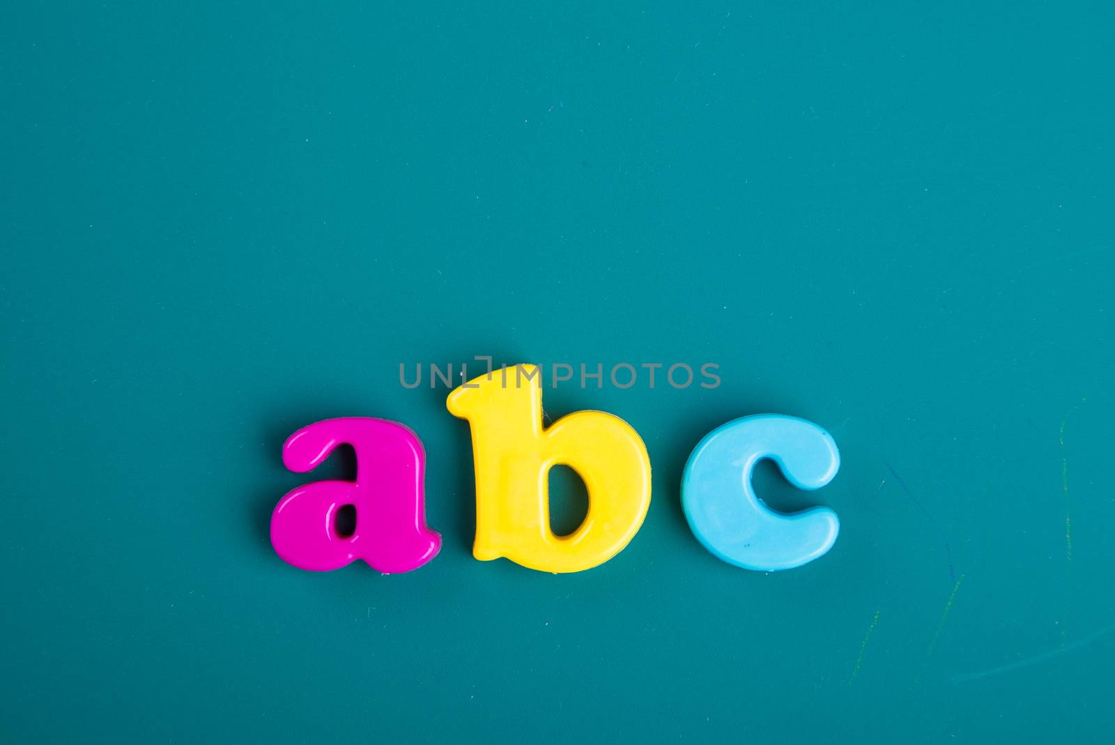Colorful Alphabet magnetic letters on green background