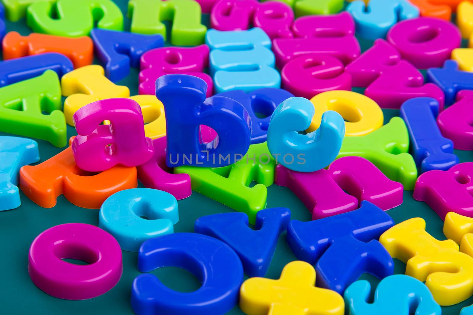 Colorful Alphabet magnetic letters on green background