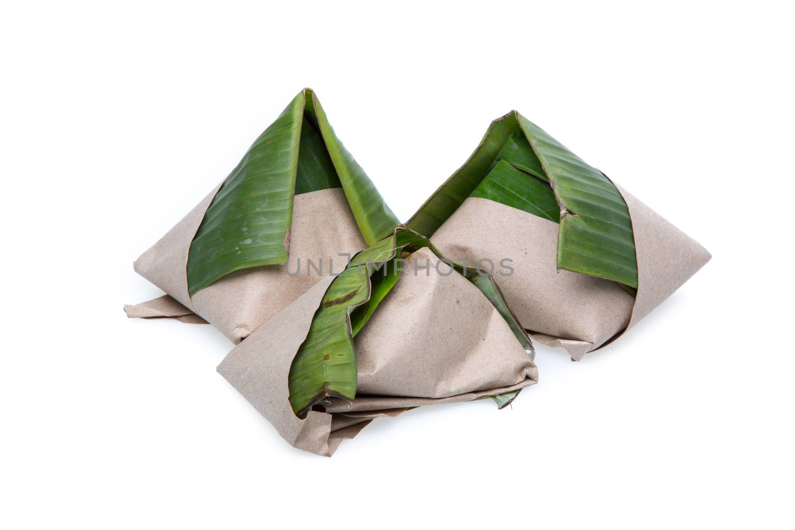 nasi lemak, a traditional malay curry paste rice dish served on a banana leaf