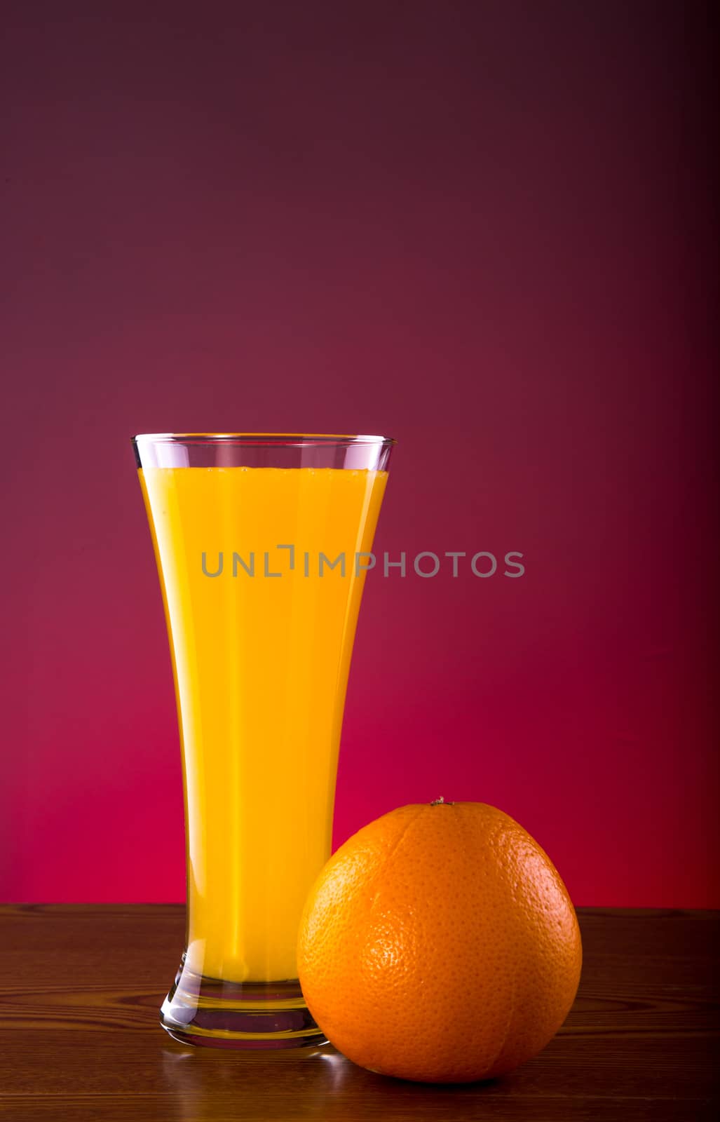 Fresh orange juice on wooden table