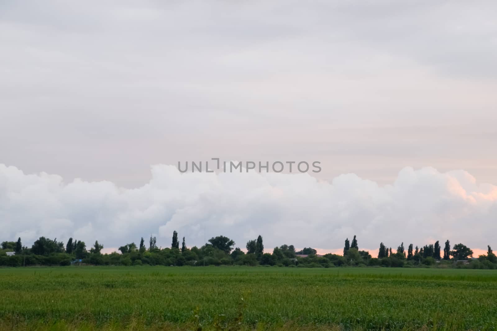 Cloudy landscape, the village before the rain, visible large cumulus clouds and clouds over the village.