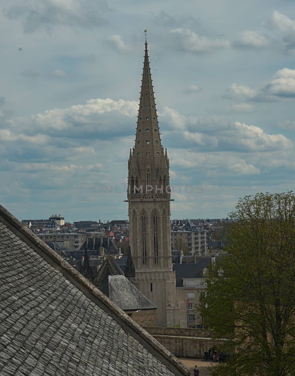 View on tall bell tower of an Catholic cathedral in Caen, France from fortress by sheriffkule