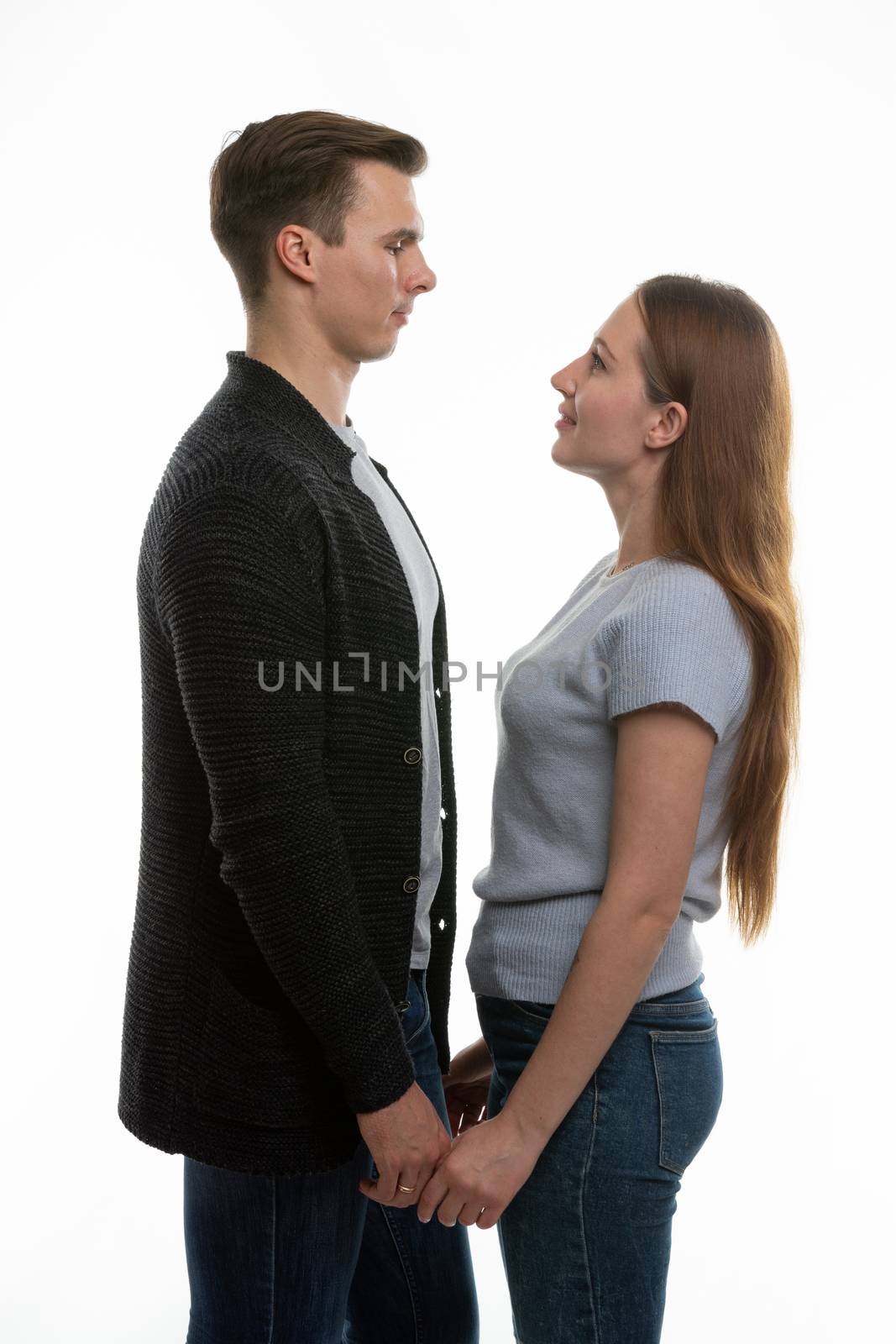 The guy and the girl are standing in front of each other and have taken their hands