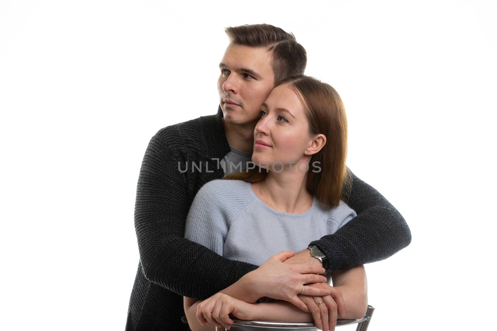 Portrait of a young couple looking to the left, a white background