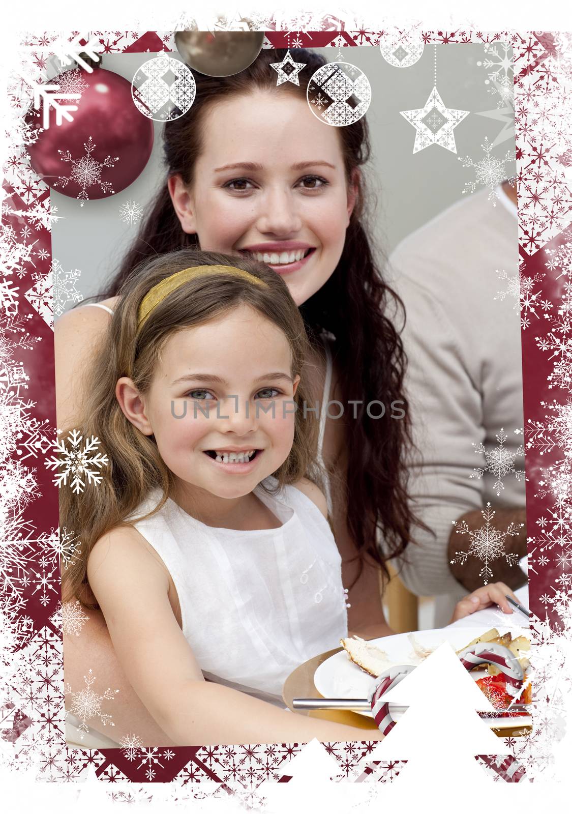 Mother and daughter having dinner with their family against christmas themed frame