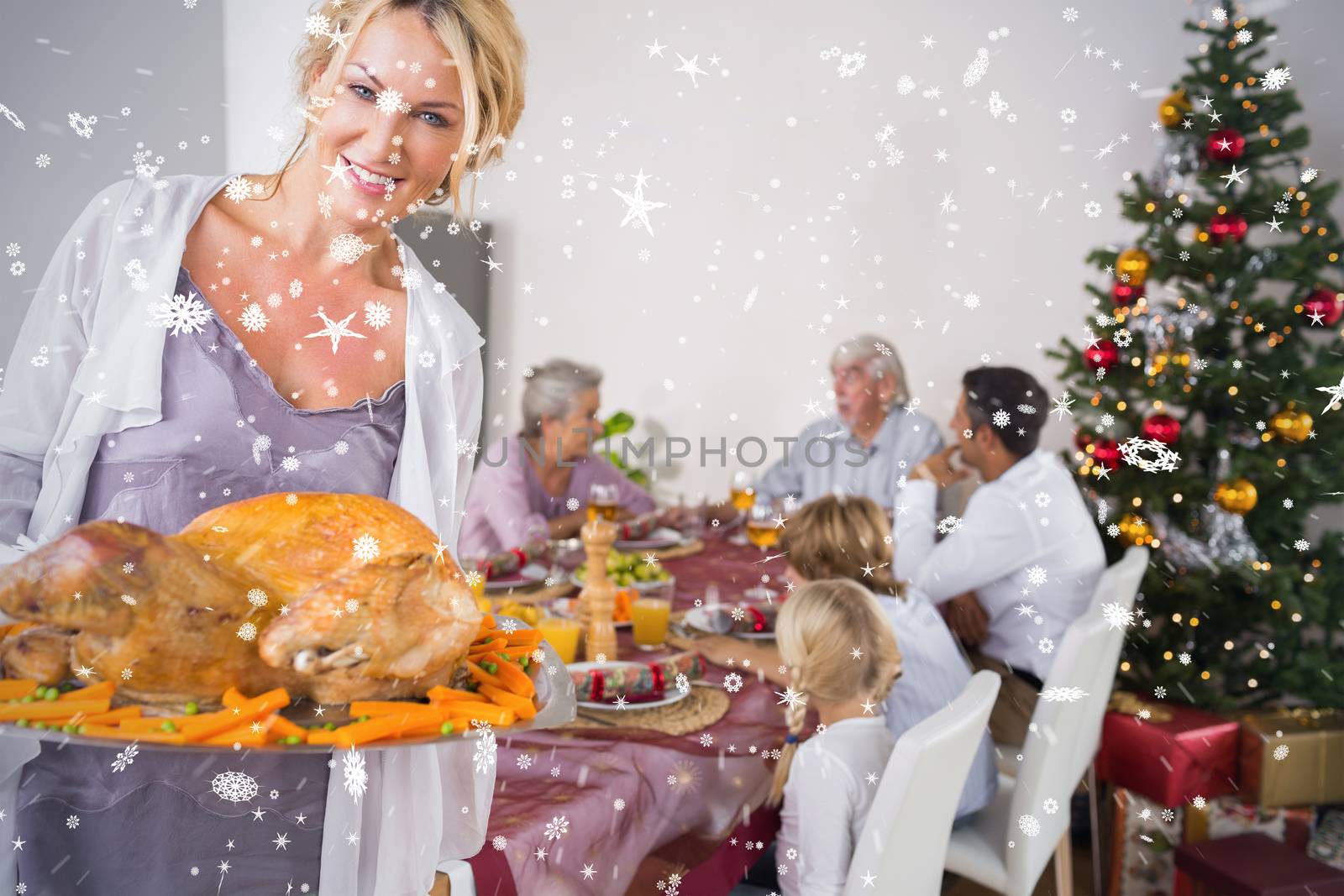 Composite image of Proud mother showing roast turkey against snow falling