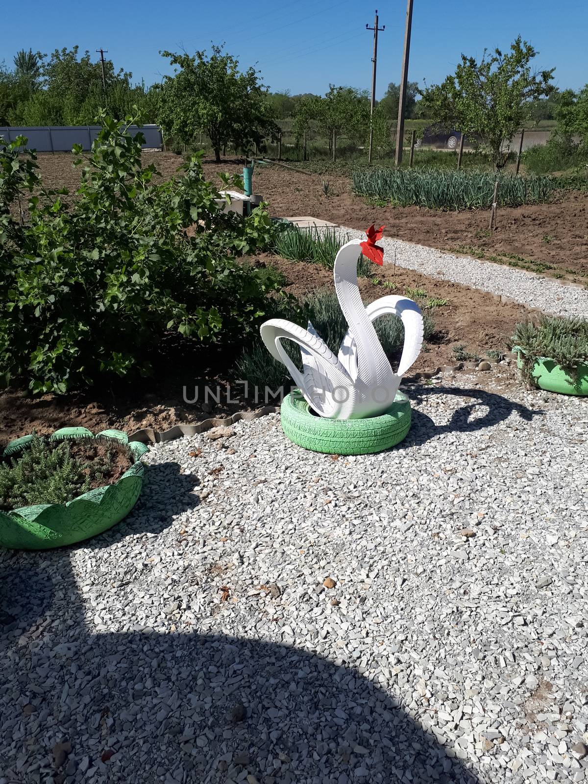 Craft from a rubber tire - a white swan. Decorations in the garden.