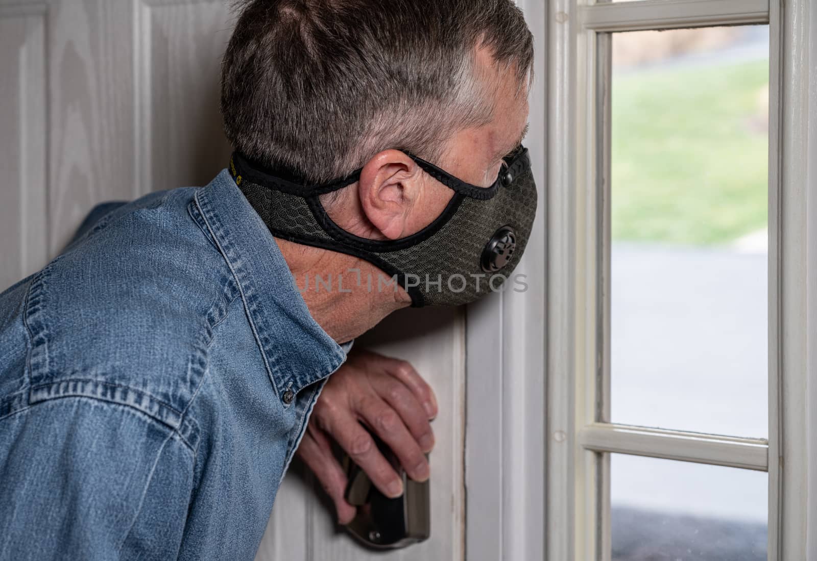Worried senior caucasian man wearing protective mask against corona virus by steheap