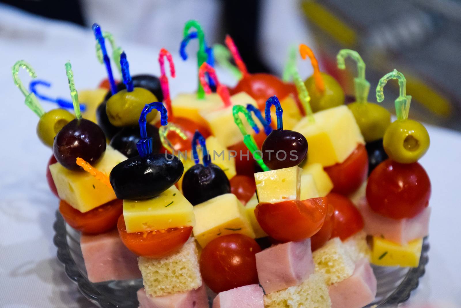 a Salad assorted, on plastic sticks vegetables and cheese.