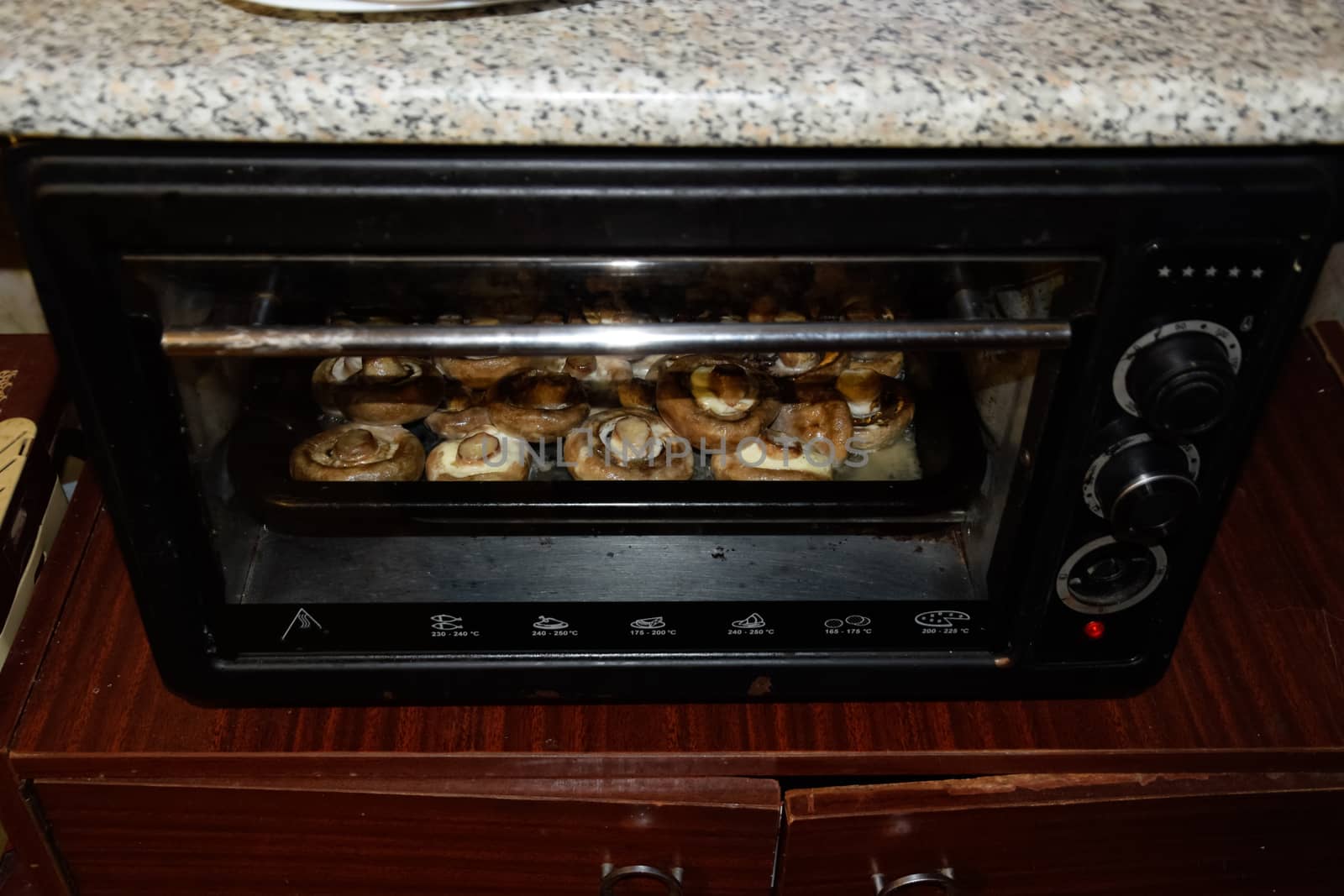 Baking mushrooms in an electric oven. Mushrooms are baked in the oven.