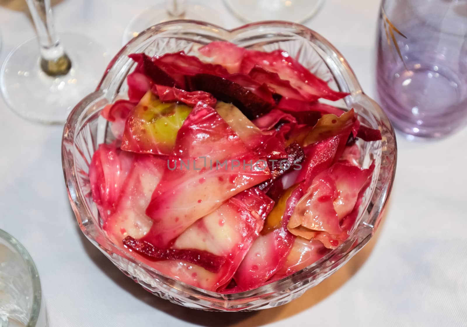 Cabbage leaf salad with beetroot. The salad is in a plate on the table.
